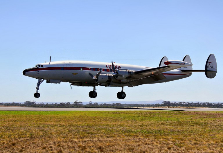 A preserved Super Constellation “Connie” comes in to land. The long nose-wheel and curved fuselage were designed to keep the longer propeller blades clear of the ground, whilst the triple lower tail enabled it to still be stored in the standard hangars of the day.