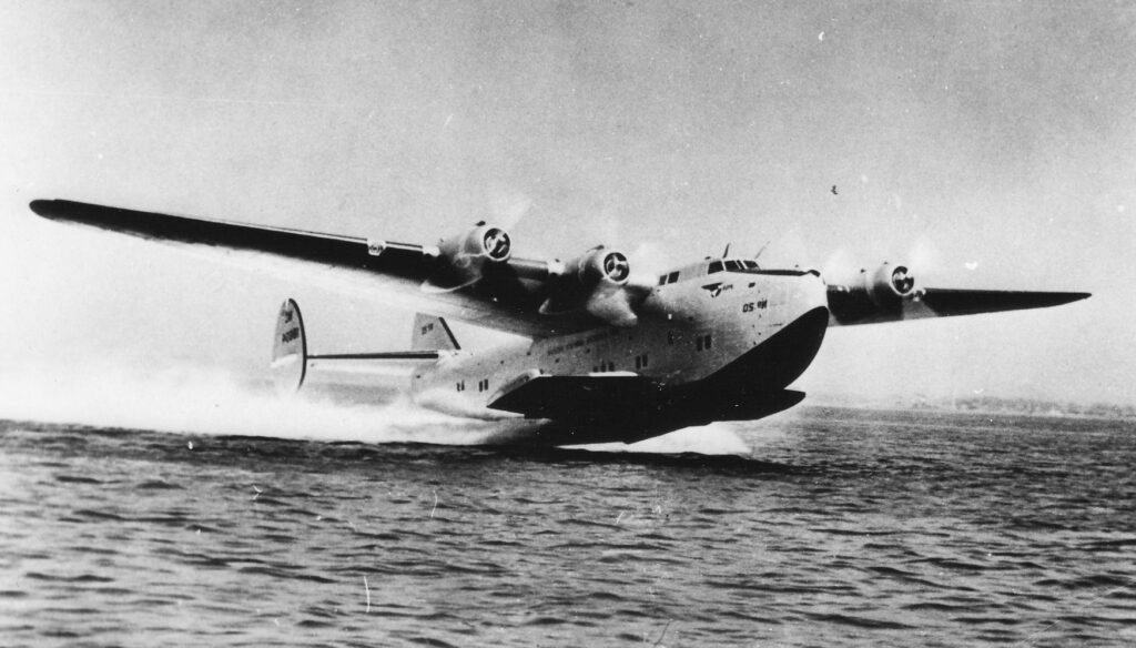 A Pan Am Boeing 314 Clipper flying boat taking off. These large flying boats brought luxury and style to air travel as never before.