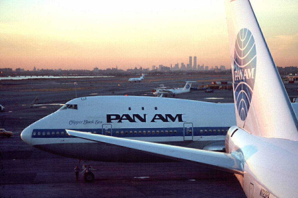 Pan Am aircraft at JFK Airport with WTC visible.